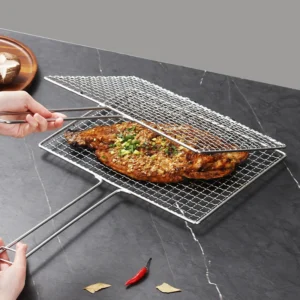 Stainless steel grill basket holding a seasoned fish on workbench setting KL-KA-BBQ-005