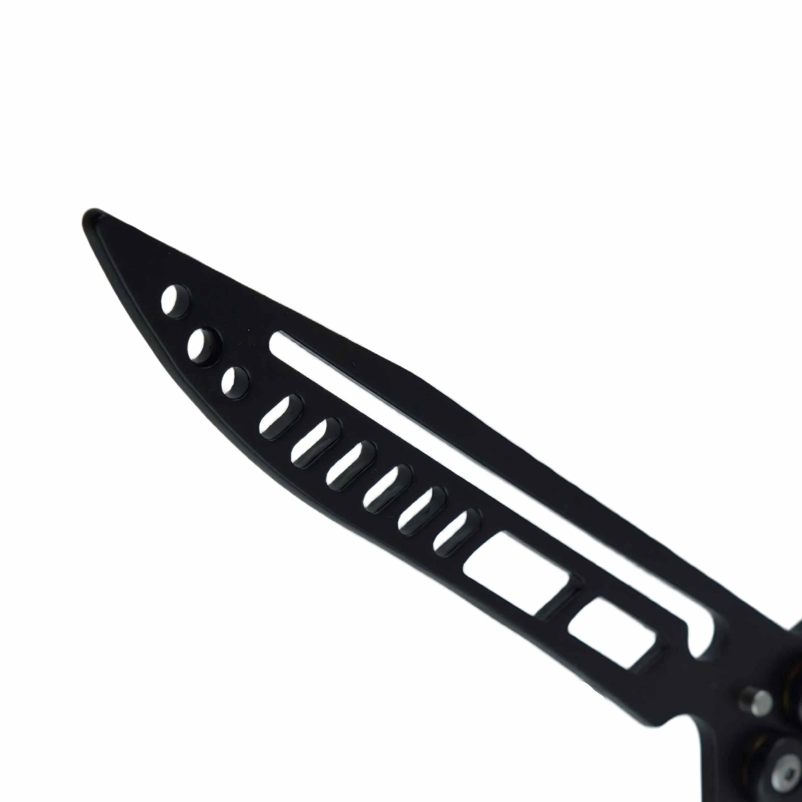Close-up of matte black skeletonized blade on balisong butterfly trainer knife, isolated on white background. KL-OD-SS-013