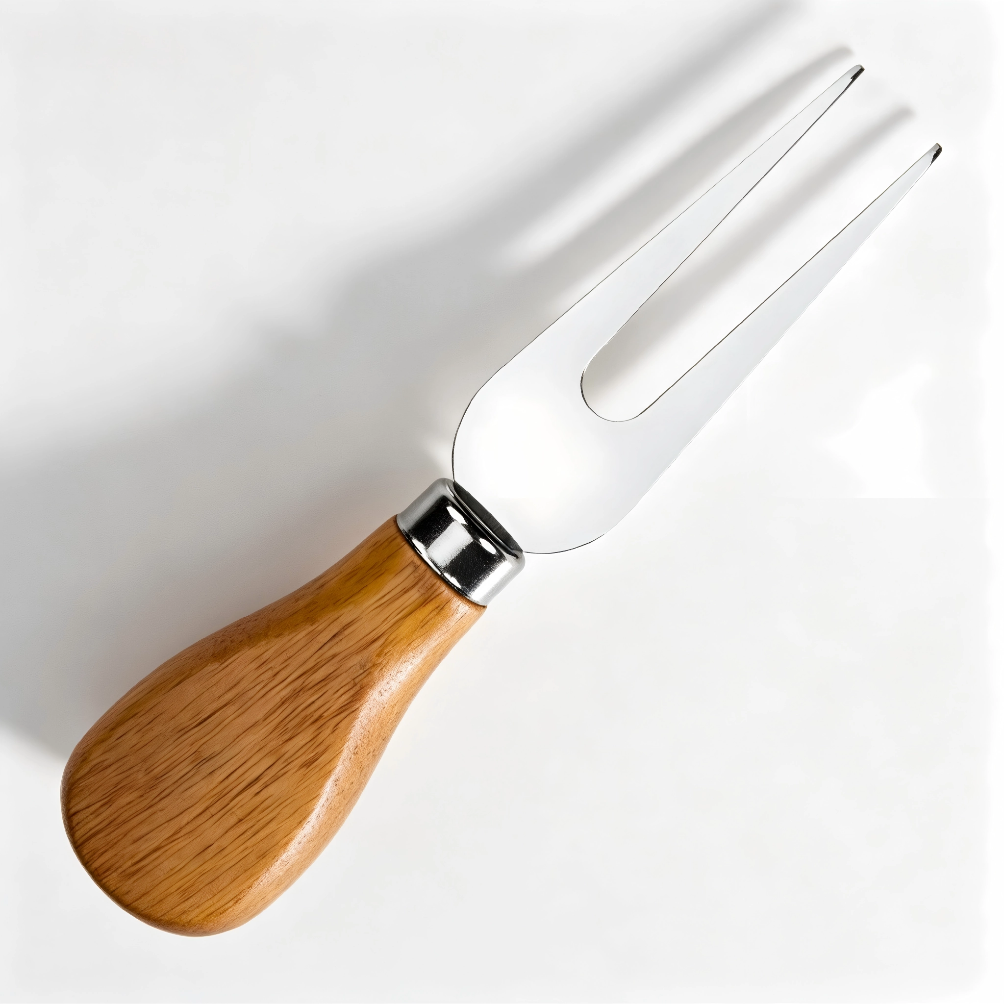 Top view of 2-tine stainless steel cheese fork with wood handle on board displayed on wooden tabletop, KL-KA-GAD-007.