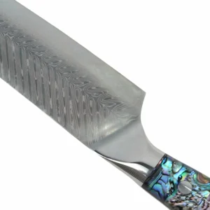 Close up view of the polished bolster and Damascus steel blade transition isolated on white background KL-KN-DS-017