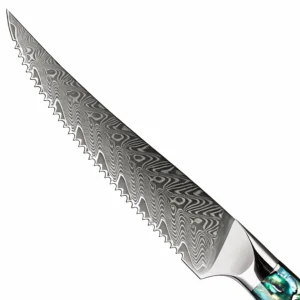 Detailed close-up of Damascus steel serrated steak knife blade isolated on white background KL-KN-OS-003