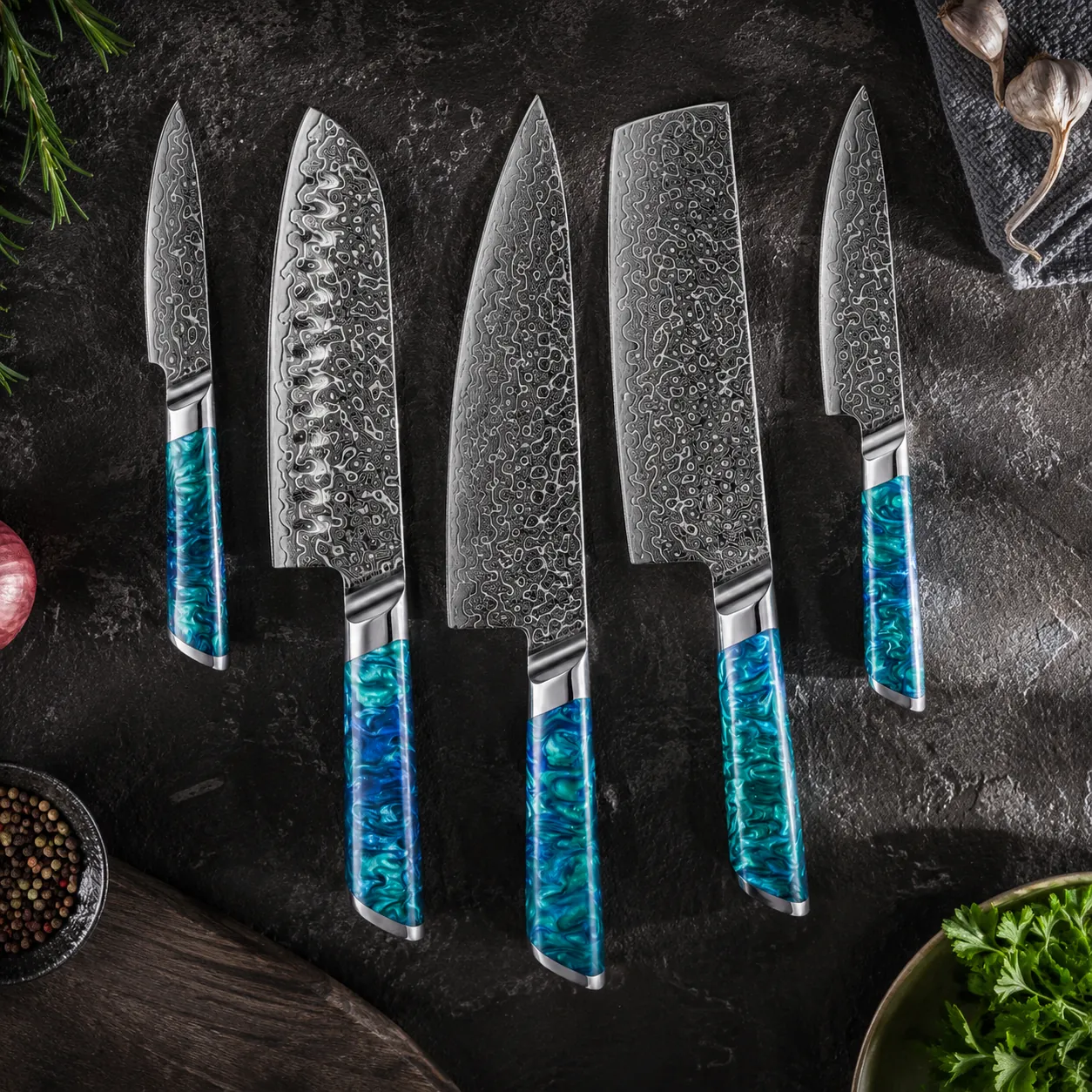 5-piece Damascus steel kitchen knife set with blue green resin handles on workbench setting. SKU: KL-KA-DS-003
