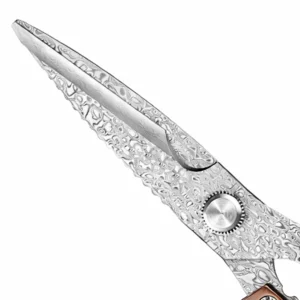 Close-up of wavy Damascus layered pattern on stainless steel kitchen shears blades isolated on white background KL-SC-KT-001