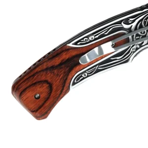Engraved Folding Pocket Knife - Detailed Rosewood Handle and Clip | KaiLionCrafts Close-up of rosewood inlay and metal pocket clip on an engraved folding knife handle, isolated on white background. KL-OD-SS-018