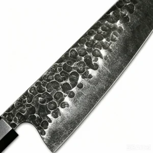 Close up of forged high carbon steel chef knife blade heel showing hammered blacksmith texture isolated on white background KL-KN-HC-007