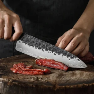 Hammered Chef Knife - Kitchen In-Use Scene | KaiLionCrafts Hand forged hammered high carbon steel chef knife kitchen scene cutting raw meat on wooden chopping board KL-KN-HC-005