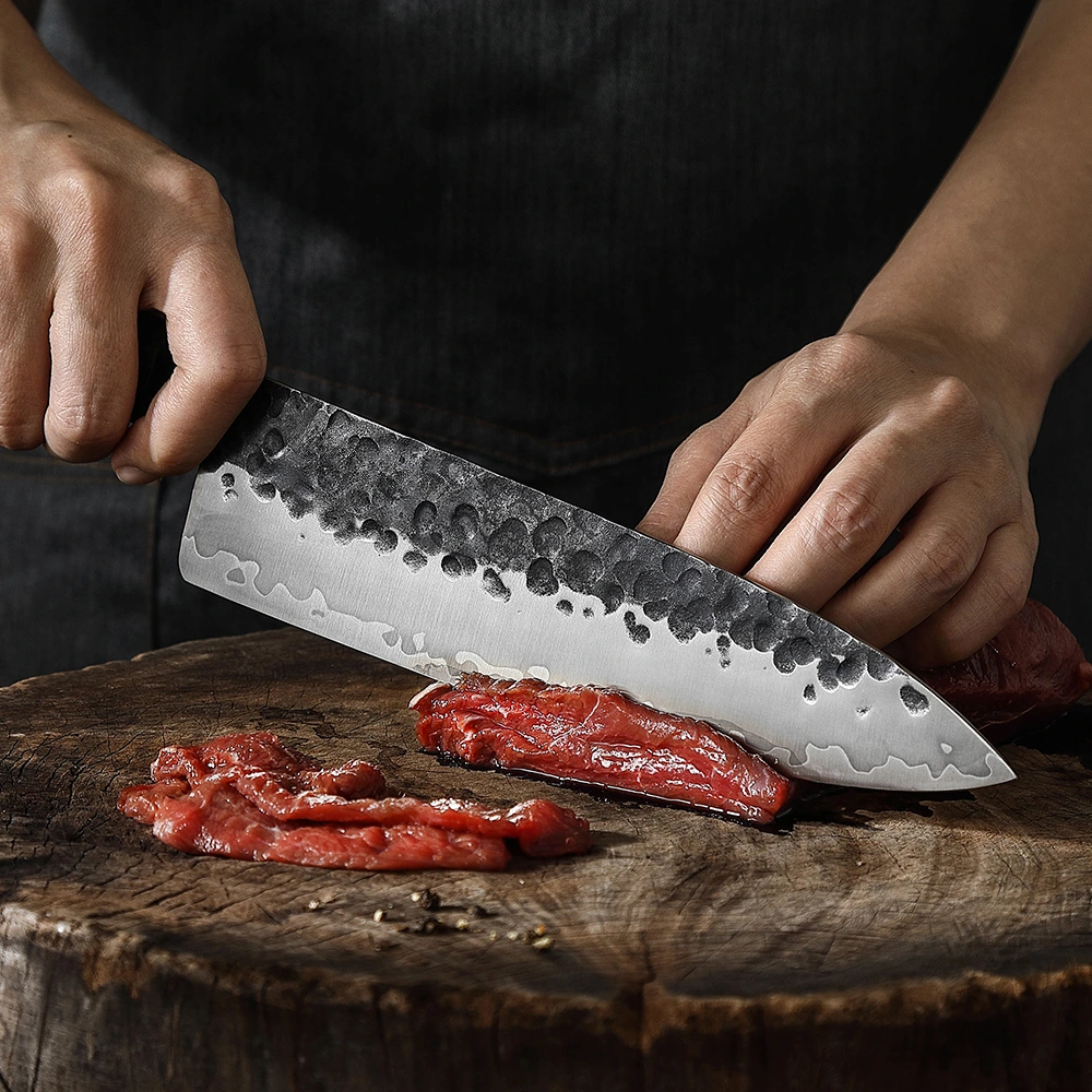 Hammered Chef Knife - Kitchen In-Use Scene | KaiLionCrafts Hand forged hammered high carbon steel chef knife kitchen scene cutting raw meat on wooden chopping board KL-KN-HC-005