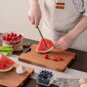 Hardwood cutting board used in kitchen environment held in hand for scale KL-KA-CB-001