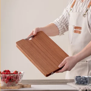 Hardwood cutting board with stainless steel handle held in hand for scale KL-KA-CB-001