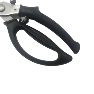 Ergonomic black plastic handle close-up with spring and lock detail on poultry shears on white background, SKU KL-SC-SS-004.