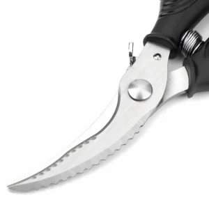 Detailed close-up of serrated blade edge and pivot screw on stainless steel poultry shears isolated on white background, SKU KL-SC-SS-004.