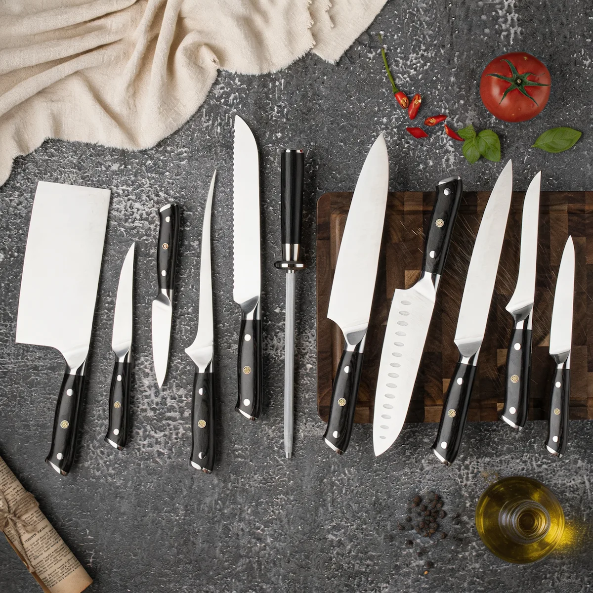 12-piece high carbon stainless steel kitchen knife set with black pakkawood handles on workbench setting. SKU: KL-KK-ST-020