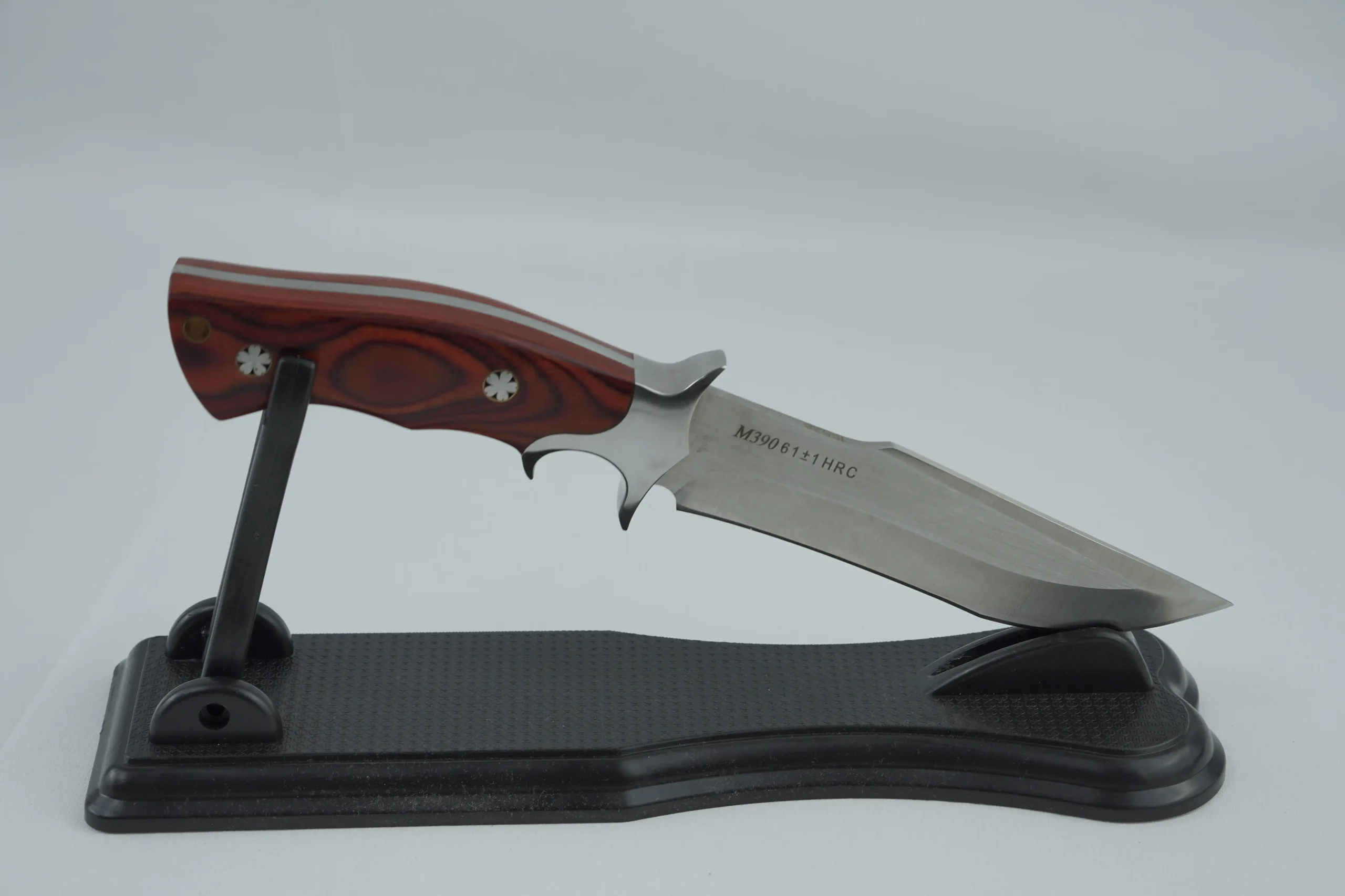 Fixed blade hunting knife with a pakkawood handle placed on a black display stand. KL-OD-HC-001-13