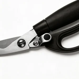 Close up of ergonomic black handle and pivot mechanism on kitchen scissors isolated on white background KL-SC-KT-002