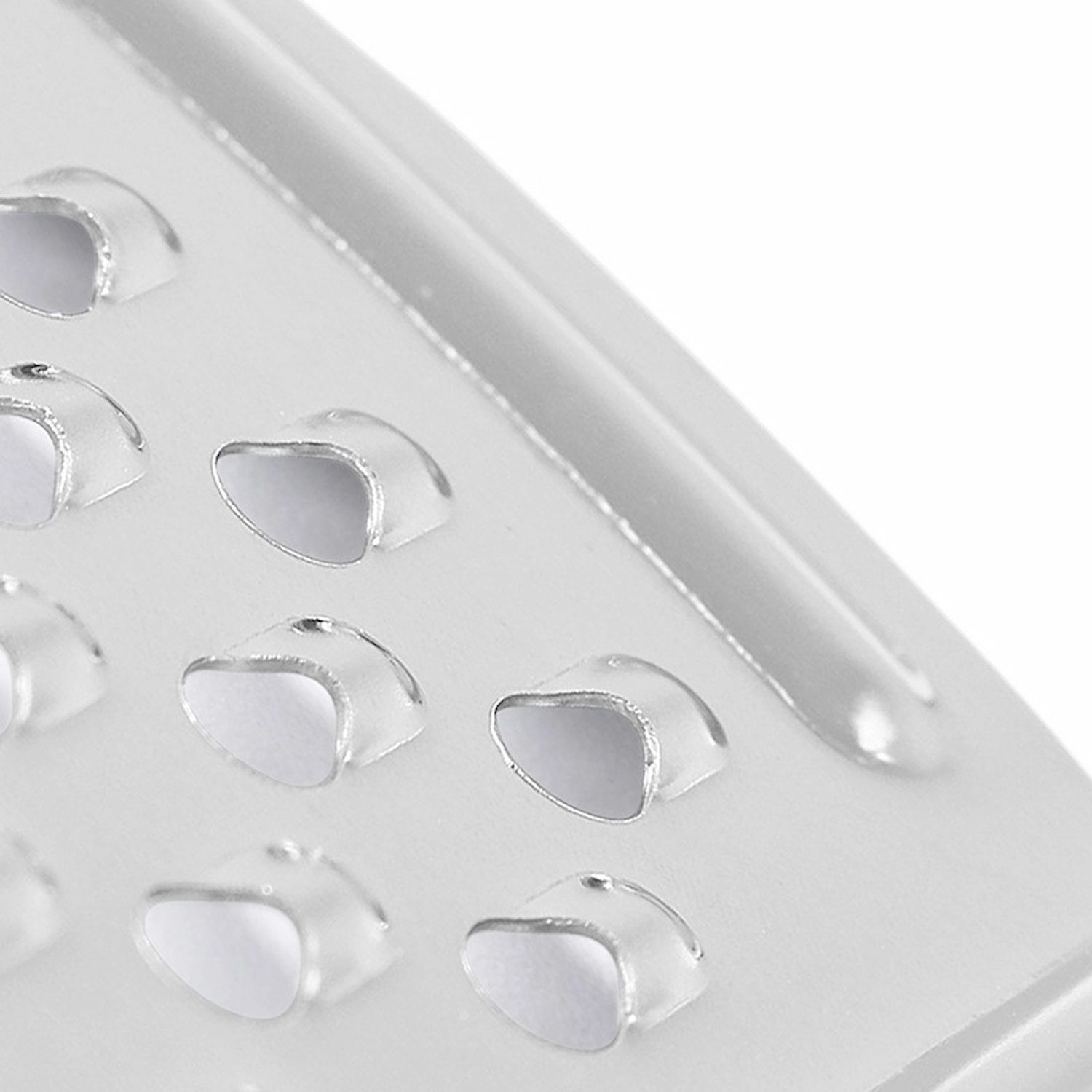 Extreme close up view of micro hole perforation details on stainless steel zester grater isolated on white background KL-KA-GR-004