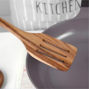 Natural wood slotted spatula blade detail on workbench setting. KL-KA-GAD-006