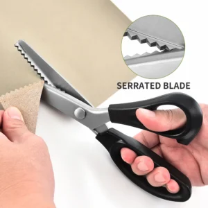 Professional stainless steel pinking shears cutting fabric held in hand for scale, SKU KL-SC-PR-001