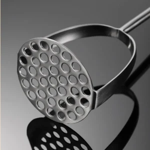 Stainless steel potato masher perforated head close up on reflective surface KL-KA-GAD-001