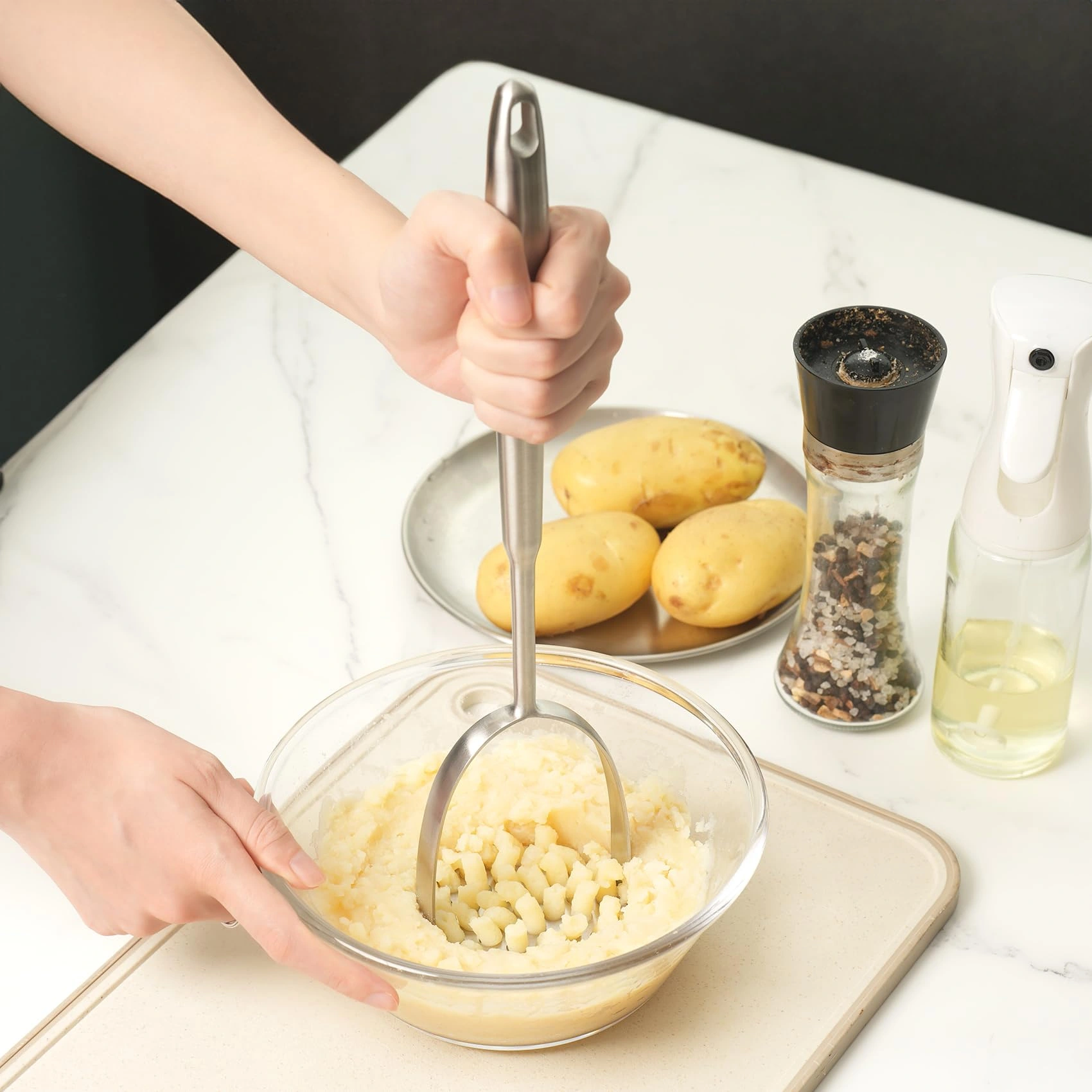 Stainless steel potato masher mashing potatoes in kitchen environment KL-KA-GAD-001