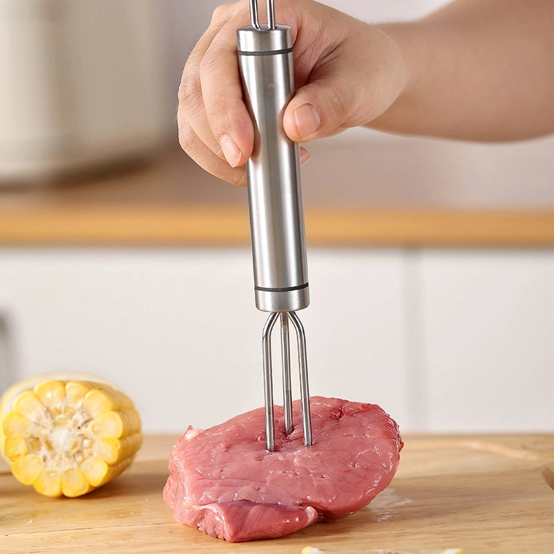 Stainless steel 4-prong BBQ meat fork held in hand for scale on wooden cutting board KL-KA-BBQ-001