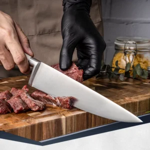 Professional stainless steel chef knife slicing raw beef on a wooden cutting board in kitchen environment. SKU: KL-KK-ST-025
