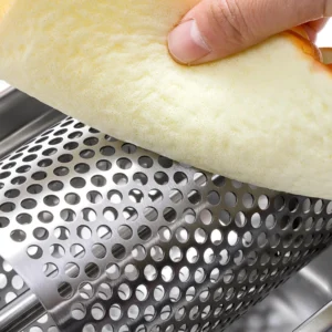 Close-up of stainless steel rotary drum grater grating food item held in hand for scale KL-KA-GR-003