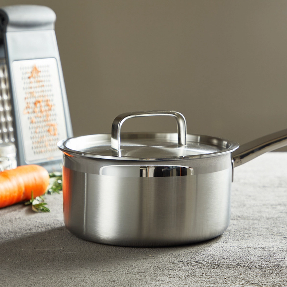 Stainless steel saucepan with lid and long handle on workbench setting KL-KA-CU-002
