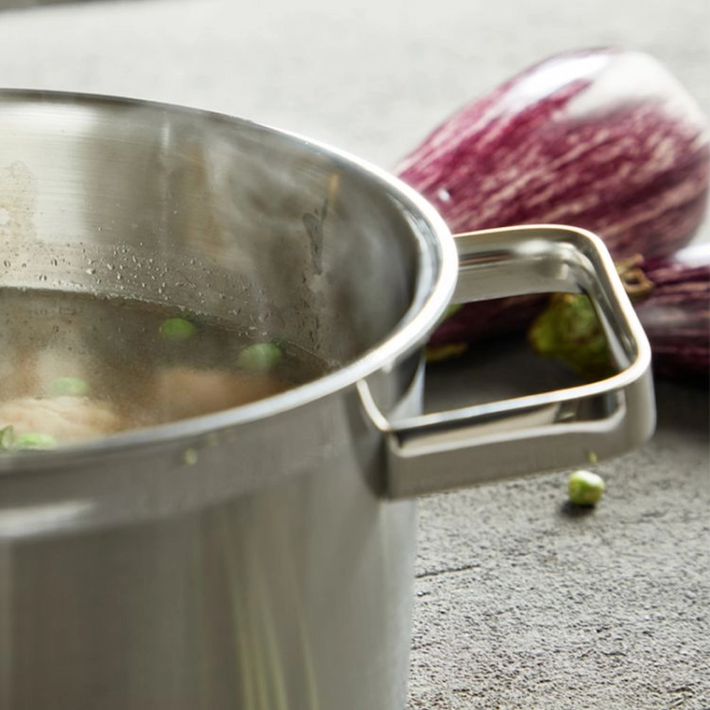 Stainless steel stock pot boiling soup with vegetables on workbench setting KL-KA-CU-001