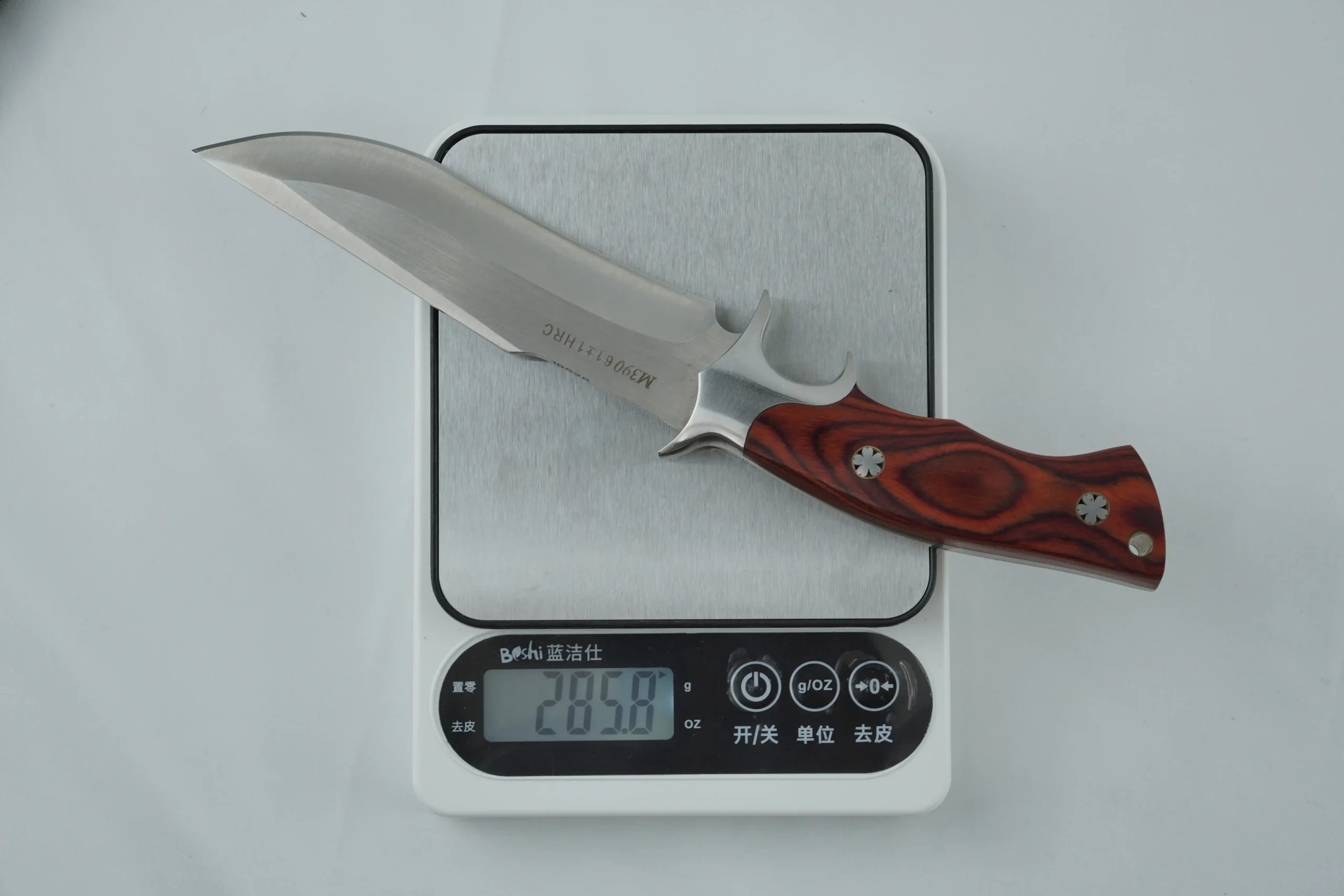 eighing a fixed blade hunting knife with a wood handle on a digital scale. KL-OD-HC-001-36